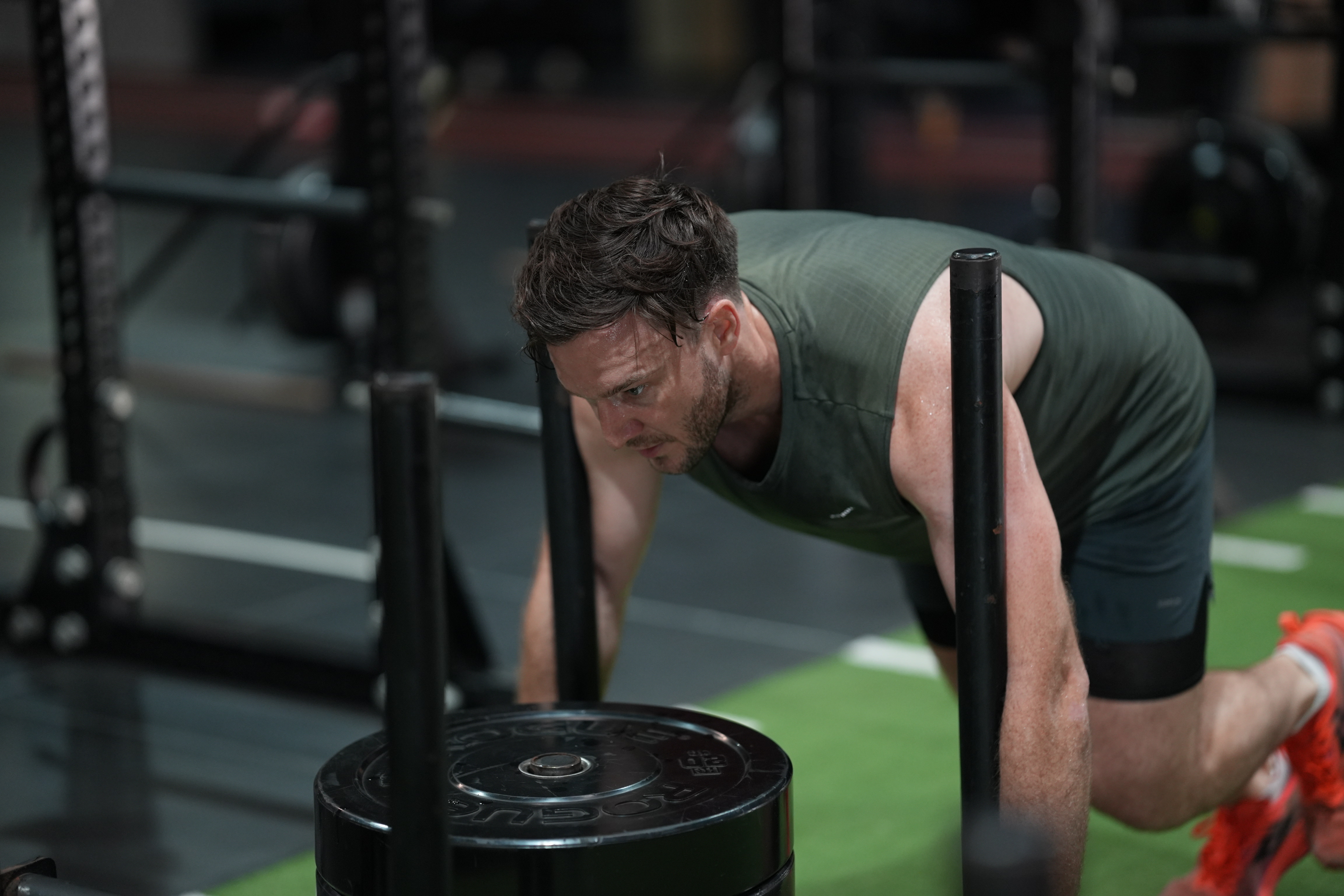 Todd Hunkin pushing weighted sled during CrossFit training